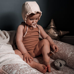 Bumibebe Hevea  Lifestyle Shot of Baby with Pink Natural Rubber Dummy