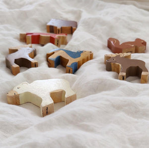 Hevea Ethically Made Rubber Wood Animals in Arctic. A Wolf Howling , a Polar Bear and a Moose.Laying on a bed 